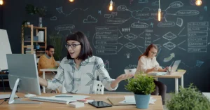 Creative team brainstorming in modern office with chalkboard wall and plants. Vibrant and dynamic environment.