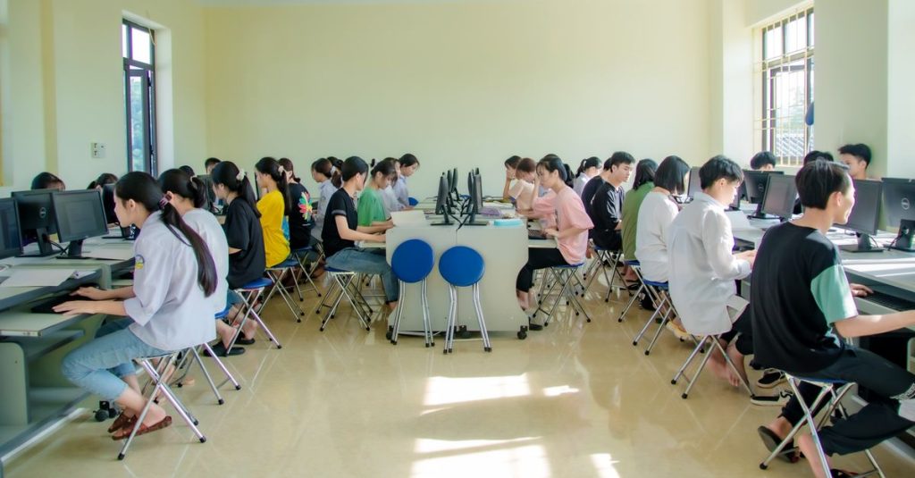 Students engaging in a group study session at a university computer lab, focused and collaborative.