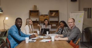 A diverse group of professionals engaged in a productive meeting in a contemporary office environment.