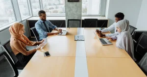 A diverse group of professionals working together in an office meeting room.
