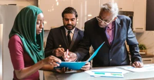 Diverse business team collaborating on a project in a stylish, modern office setting.