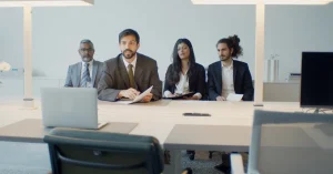 A diverse team in a business meeting using video conference in a modern office setting.