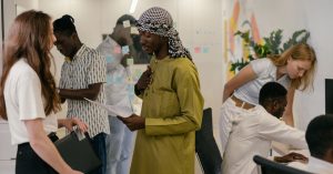 Diverse team engaged in discussion and collaboration in a modern office setting, showcasing teamwork and diversity.